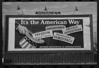 Vintage, black and white Photograph of a billboard sign that reads it's the American way